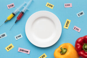 Image depicts food additives and preservative in the not form spread around a plate. Showing the are added to food.